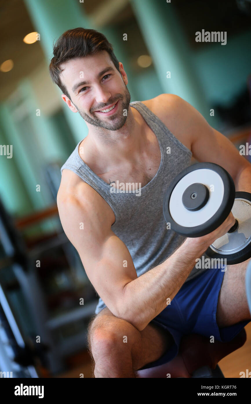 Man lifting weights in fitness center Stock Photo