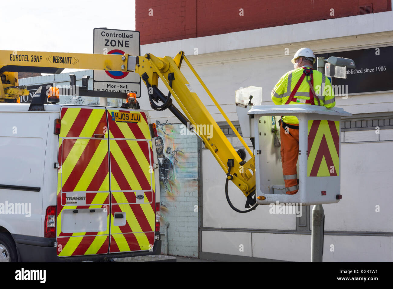 Council worker changing street lamp from van mounted hydraulic lift, Richmond, Borough of Richmond upon Thames, London, England, United Kingdom Stock Photo