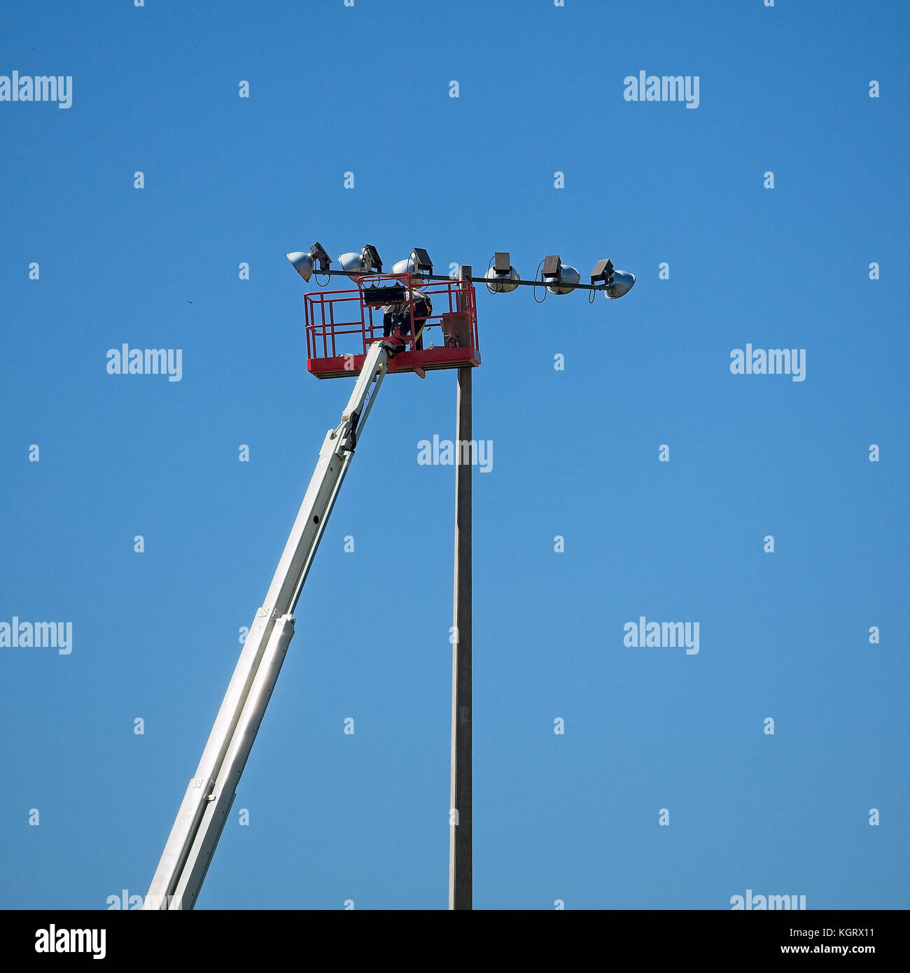 Spring TX USA - Oct. 17, 2017  -  Worker up in the air servicing field lights. Stock Photo