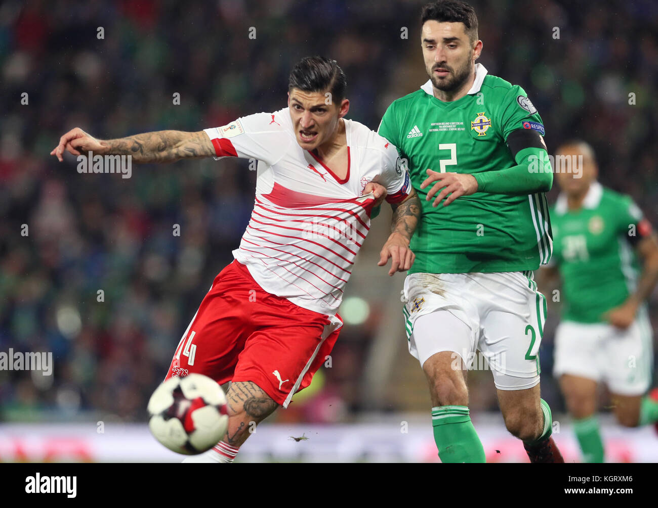 Switzerland's Steven Zuber (left) and Northern Ireland's Conor McLaughlin battle for the ball during the 2018 World Cup Qualifying Play-Off, First Leg match at Windsor Park, Belfast. Stock Photo