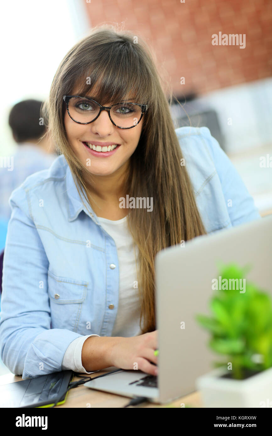 Young woman working with graphic tablet in office Stock Photo