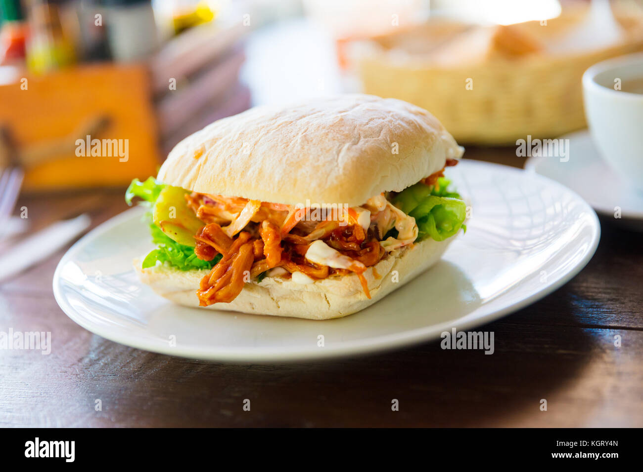 Pulled Pork Burger Served On Restaurant Table Stock Photo