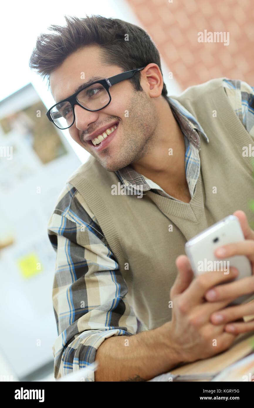 Young man connected on internet with smartphone Stock Photo - Alamy