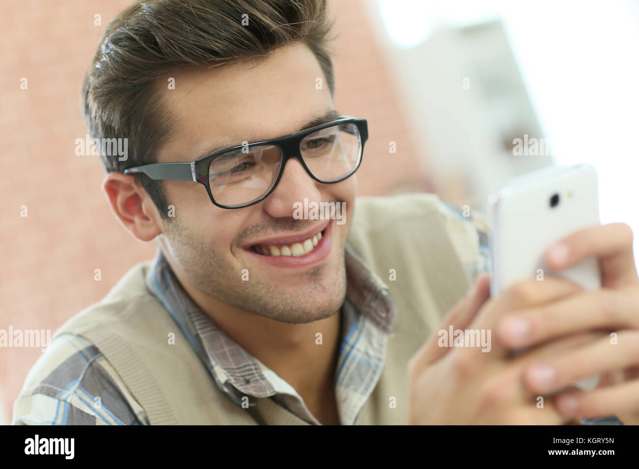 Young man connected on internet with smartphone Stock Photo - Alamy