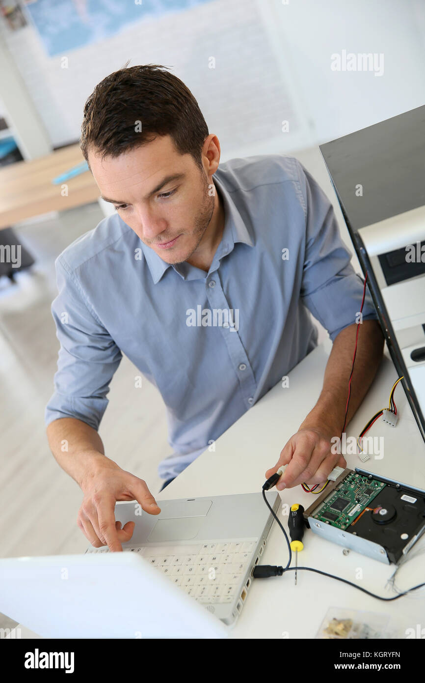 Engineer proceeding to data recovery from computer Stock Photo