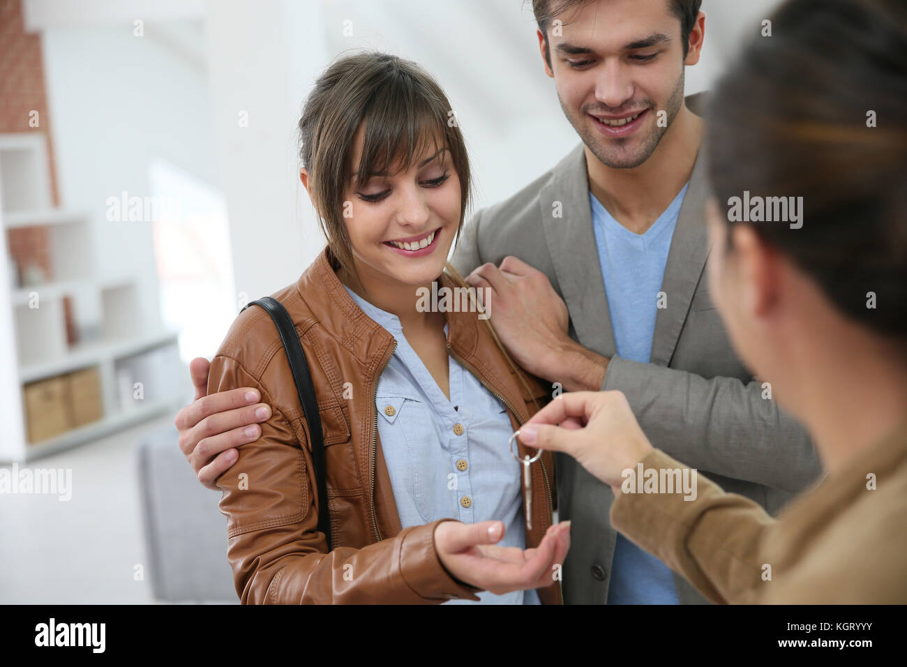 Happy young couple getting key of their new place Stock Photo - Alamy