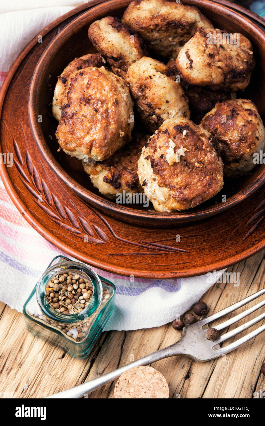 Homemade cutlets in clay ware on a wooden background.Ukrainian food Stock Photo