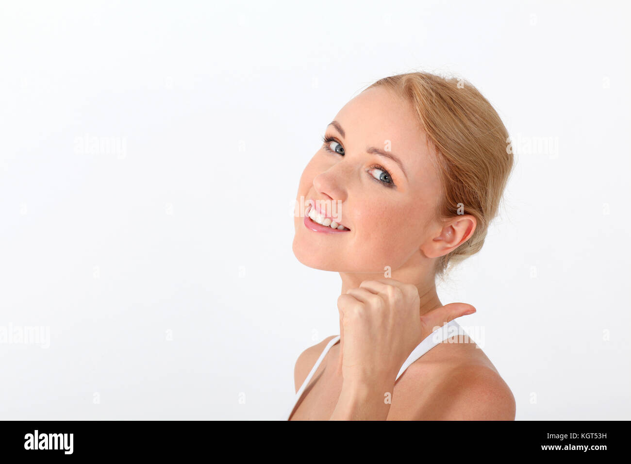 Smiling blond woman showing thumb up on white background Stock Photo ...