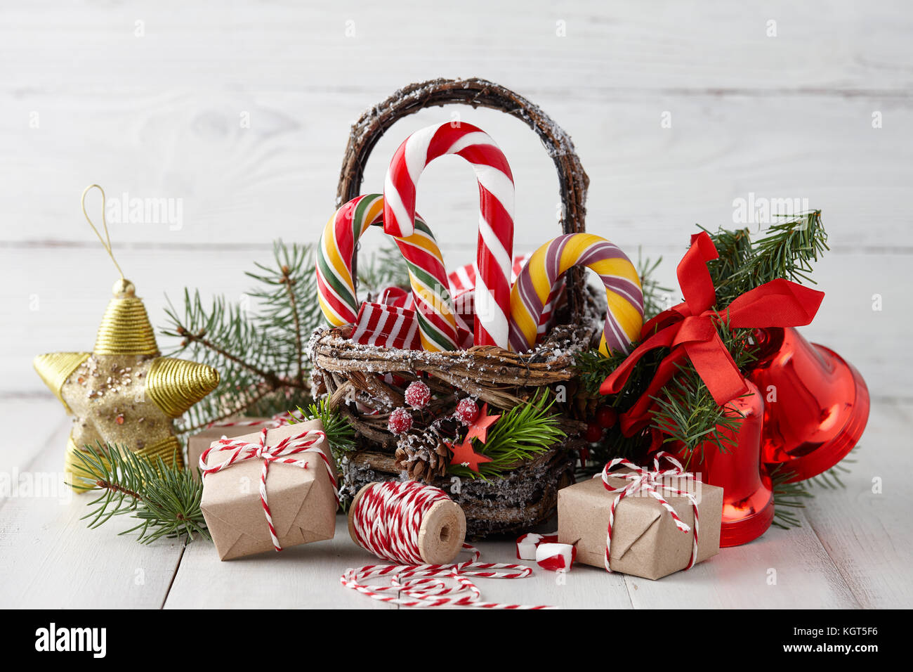 Christmas basket with candy canes on white planks Stock Photo Alamy
