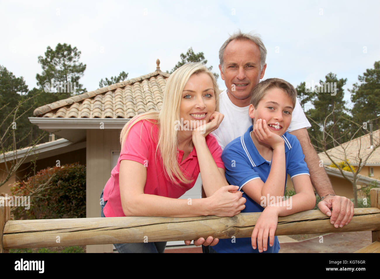 Family standing in front of their house Stock Photo - Alamy