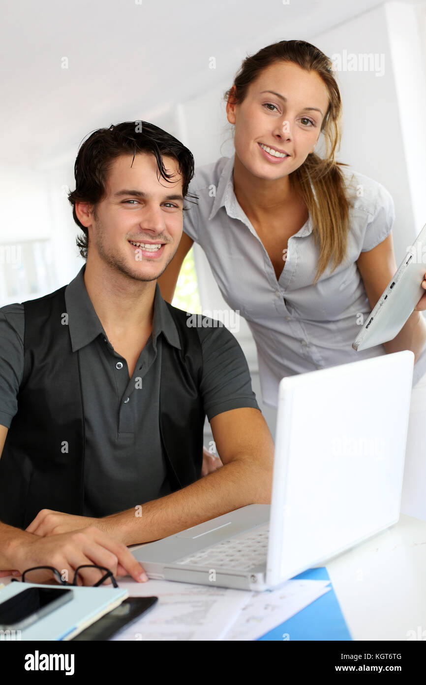 Coworkers in office discussing project Stock Photo Alamy