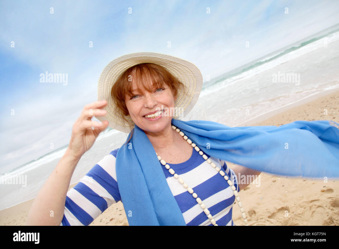 Portrait of smiling senior woman at the beach Stock Photo - Alamy