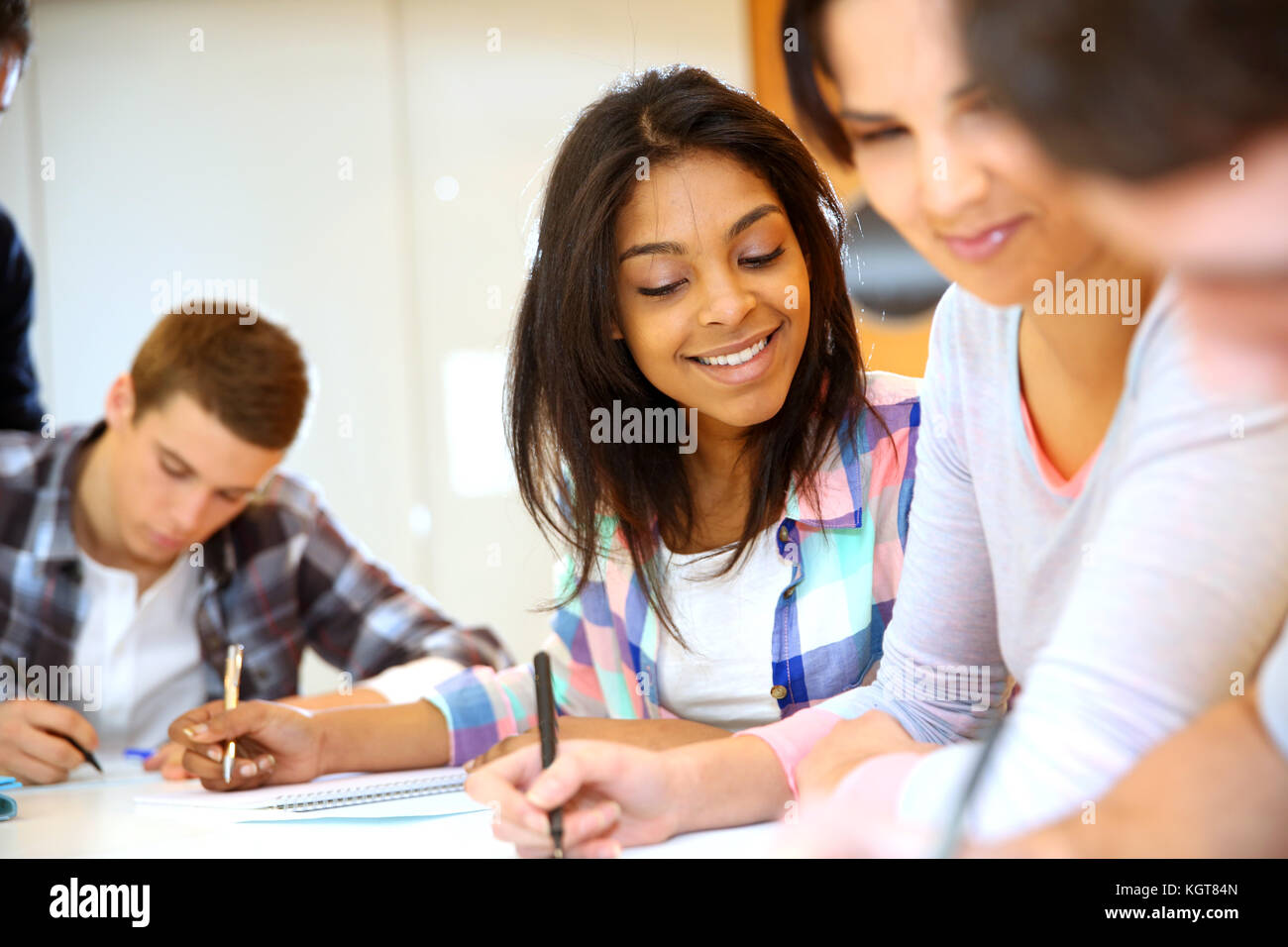 Group of teenagers in class writing an exam Stock Photo