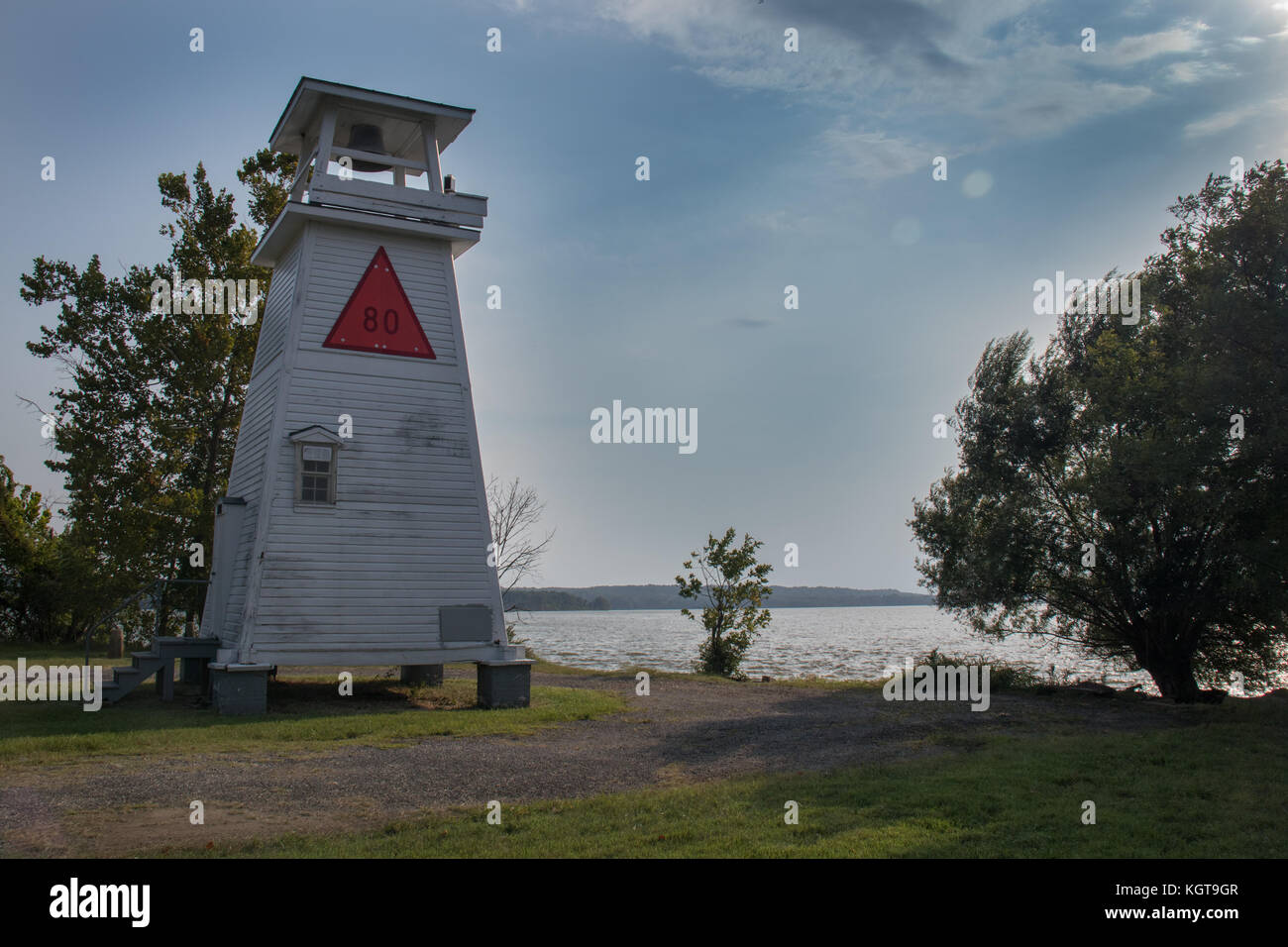 White fog bell tower on the river at sunset Stock Photo