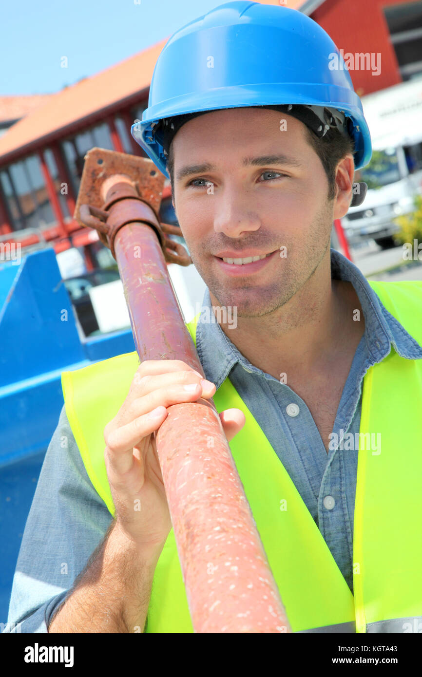 Worker lifting prop on construction site Stock Photo Alamy