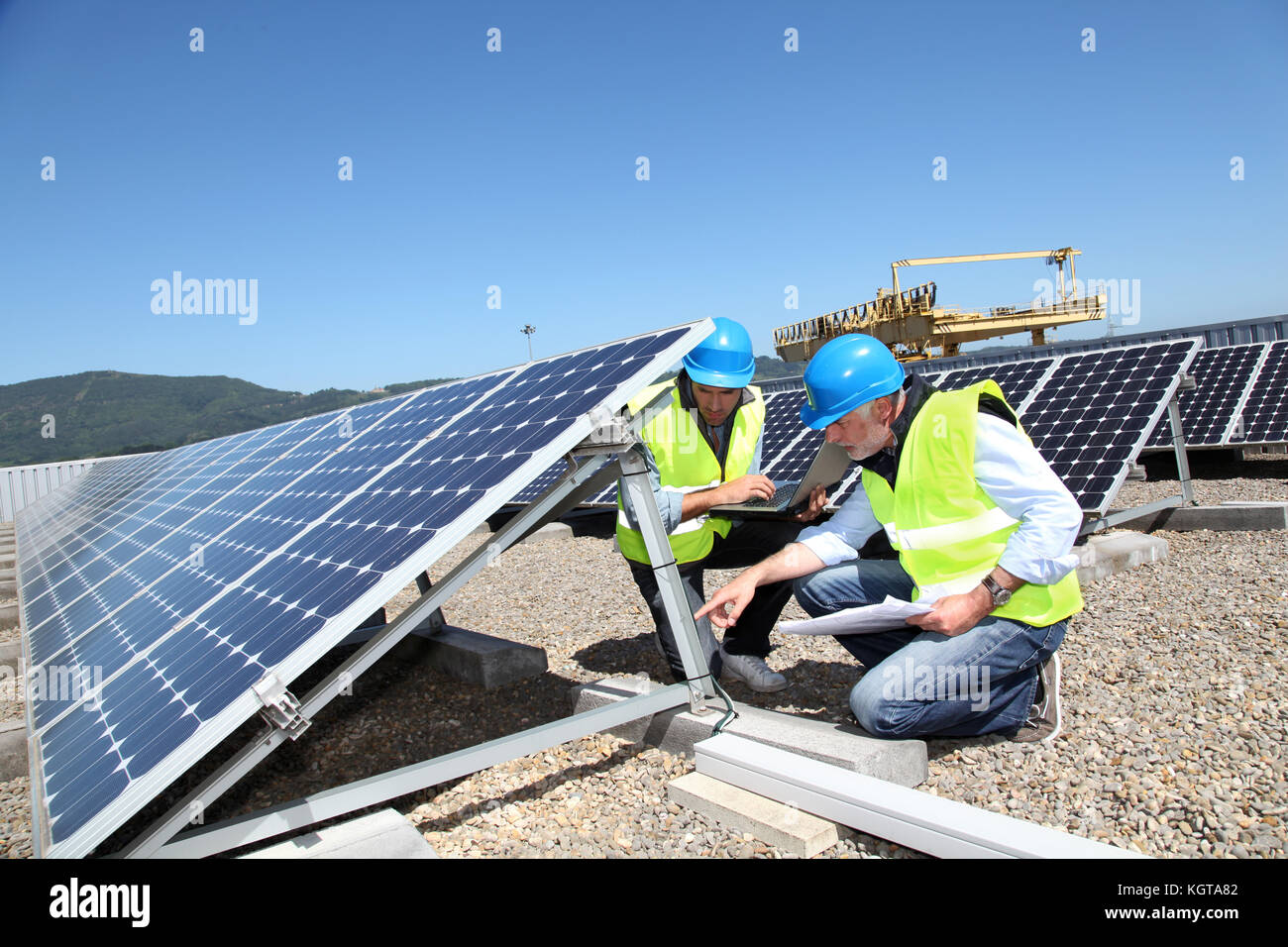 Engineers checking solar panels running Stock Photo - Alamy