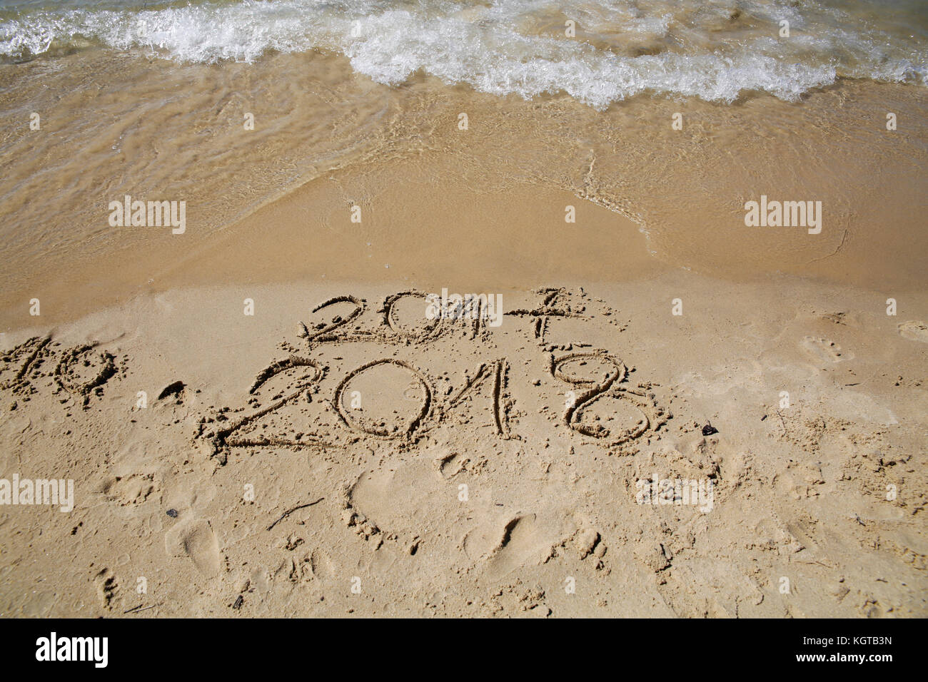Sandy beach with current year written Stock Photo
