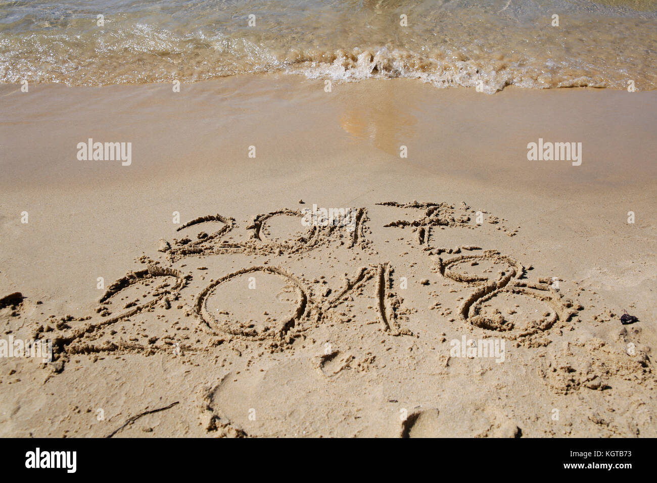 Sandy beach with current year written Stock Photo
