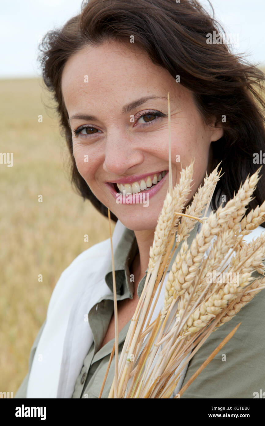 Beautiful woman standing in wheat field Stock Photo - Alamy