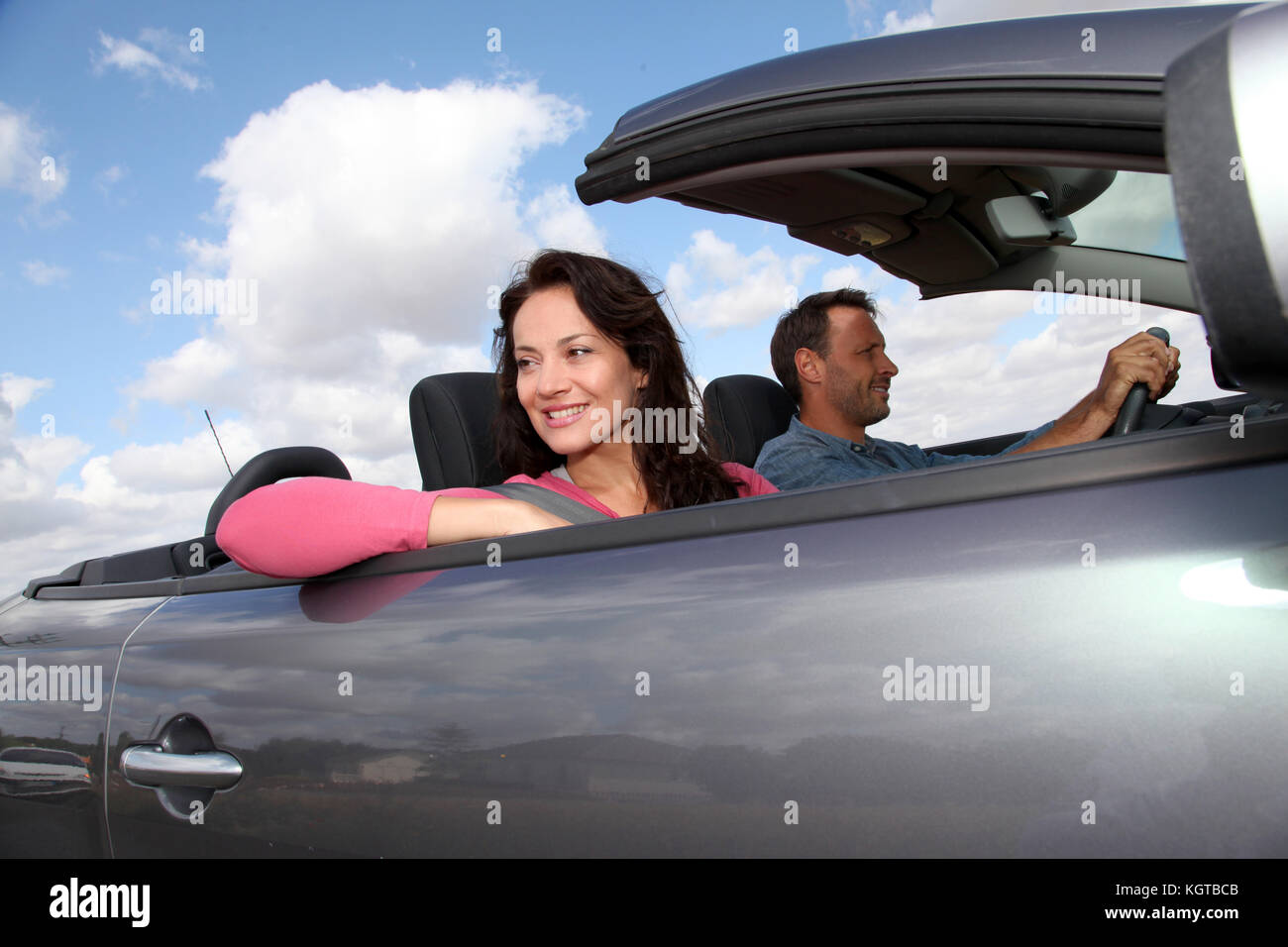 Couple riding convertible car Stock Photo - Alamy