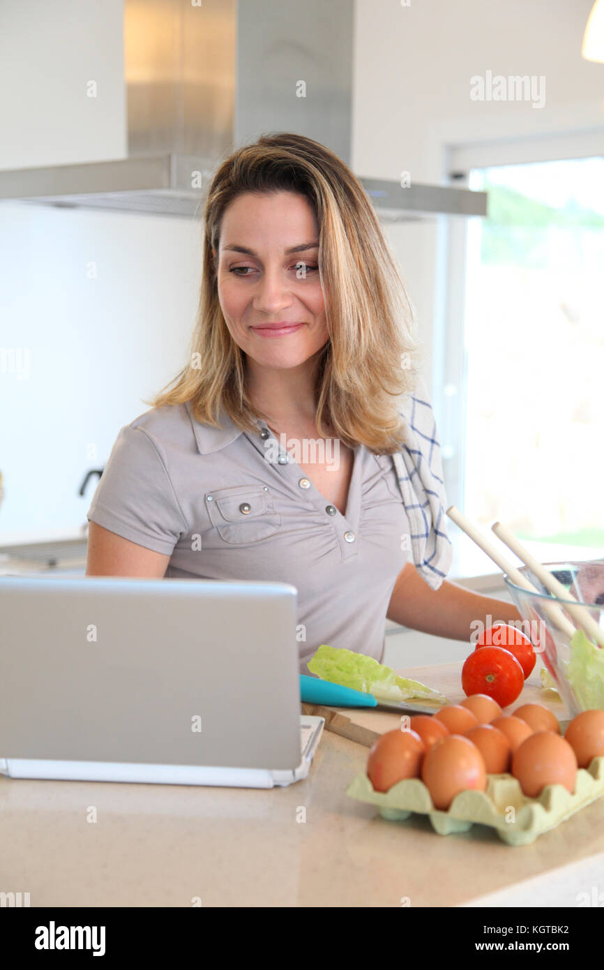 Woman in kitchen preparing lunch Stock Photo