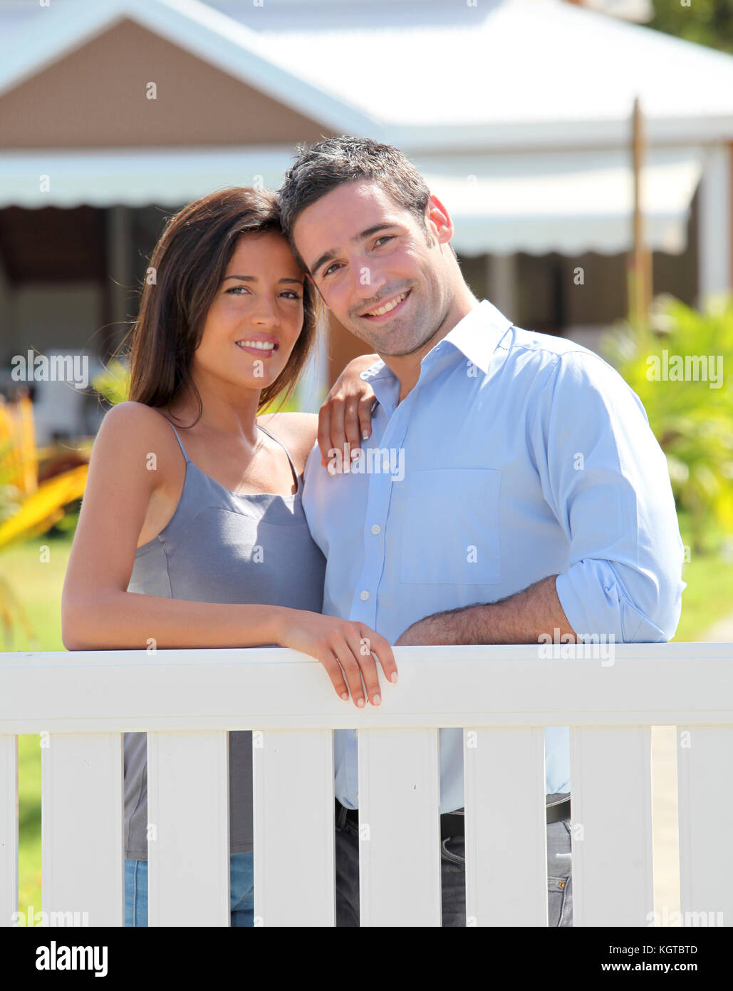 Couple standing in front of new home Stock Photo - Alamy