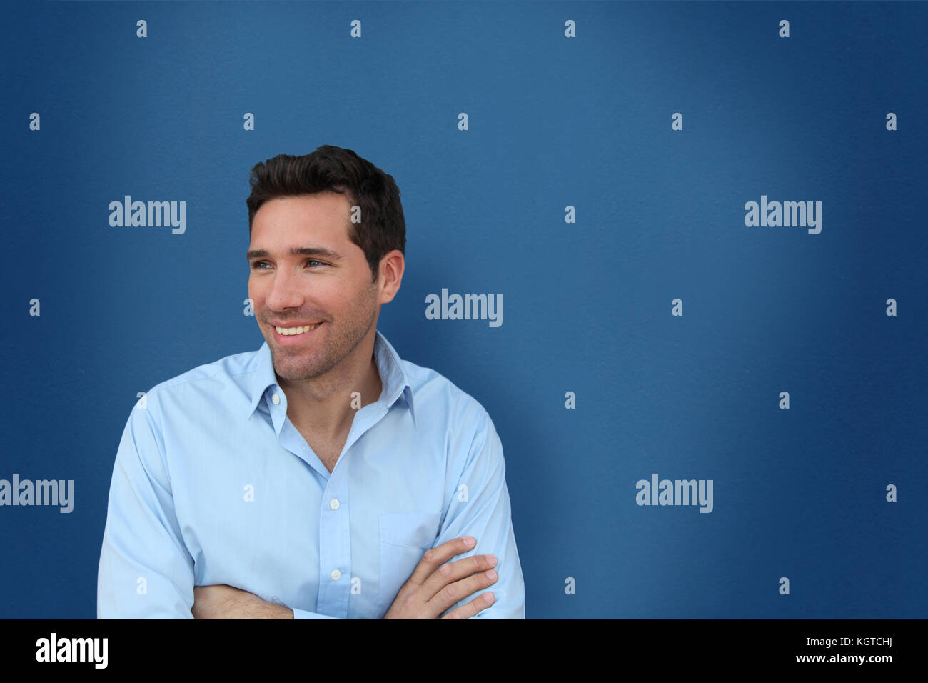 Portrait of handsome man standing on blue background Stock Photo - Alamy