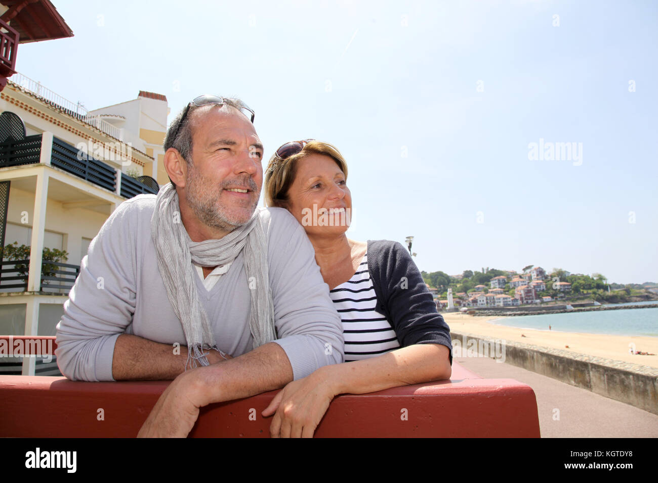 Senior couple in seaside resort looking at the beach Stock Photo - Alamy