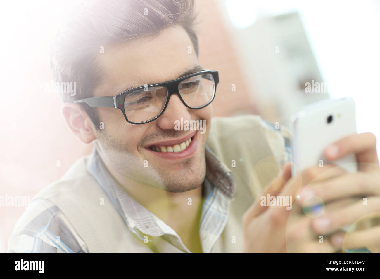 Young man connected on internet with smartphone Stock Photo - Alamy