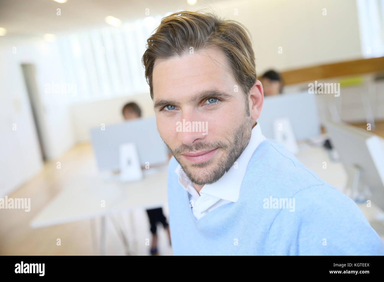 Portrait of smiling businessman in office Stock Photo - Alamy
