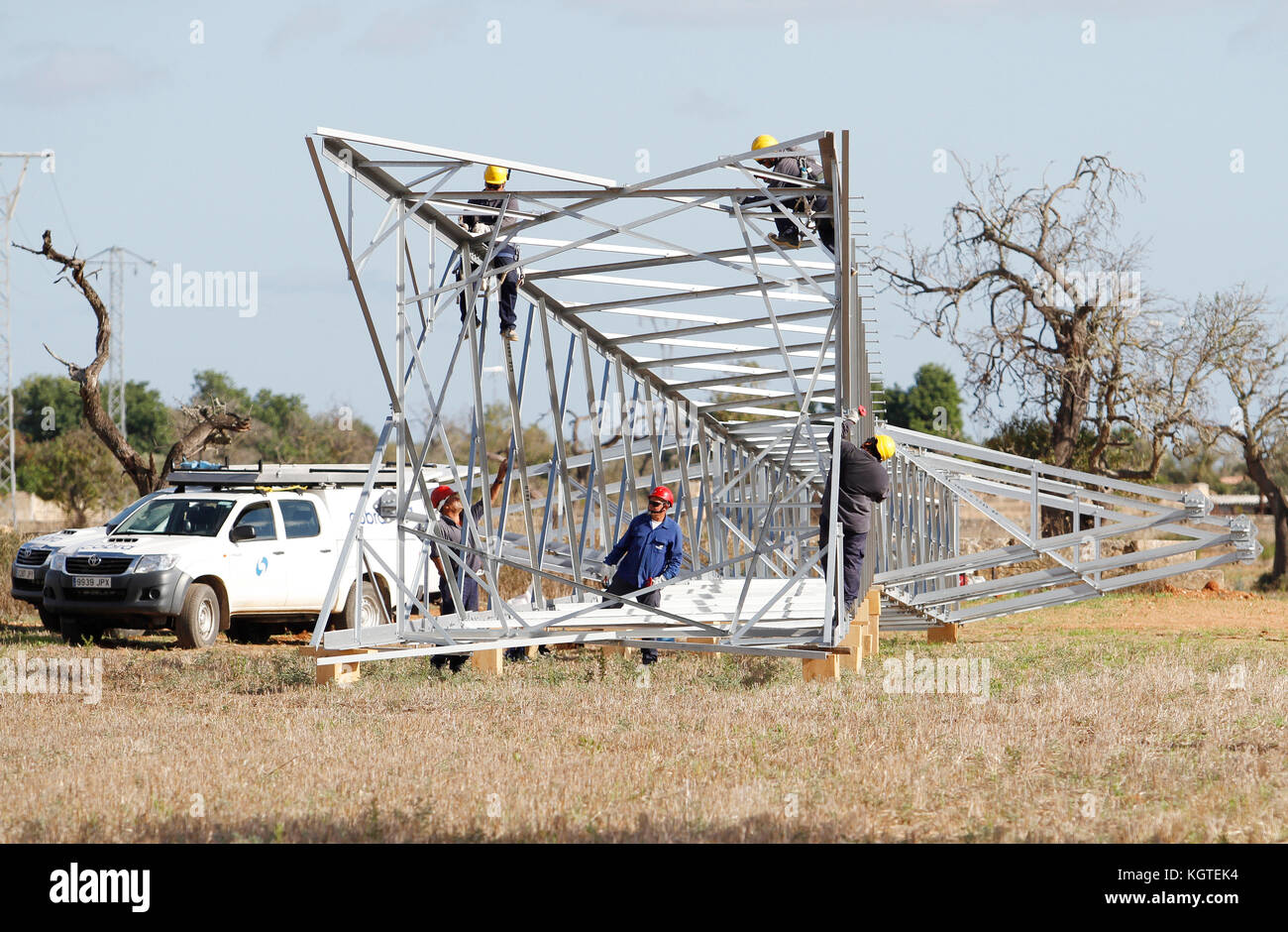Workers install electrical high tension towers in Mallorca. Stock Photo