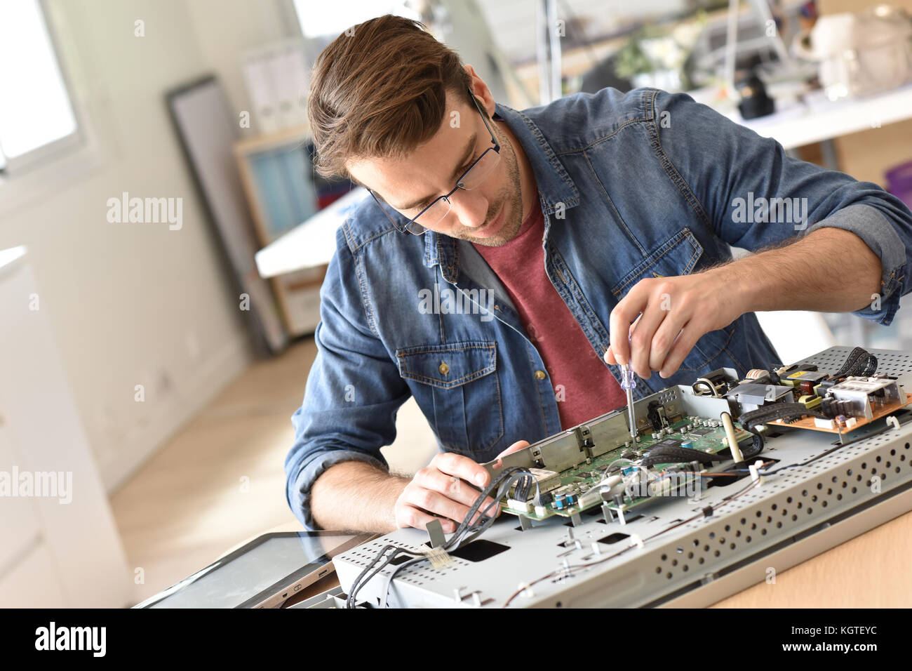 Repairman fixing tv set Stock Photo Alamy