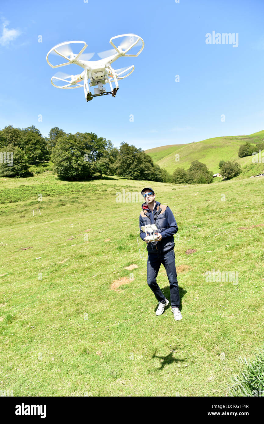 Man handling drone in nature Stock Photo