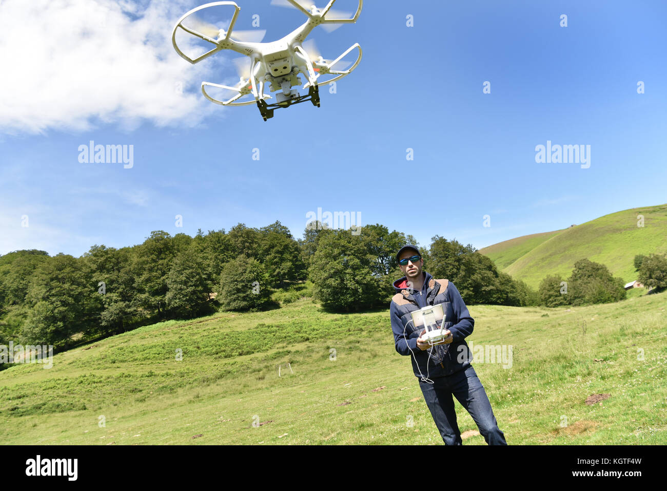 Man handling drone in nature Stock Photo