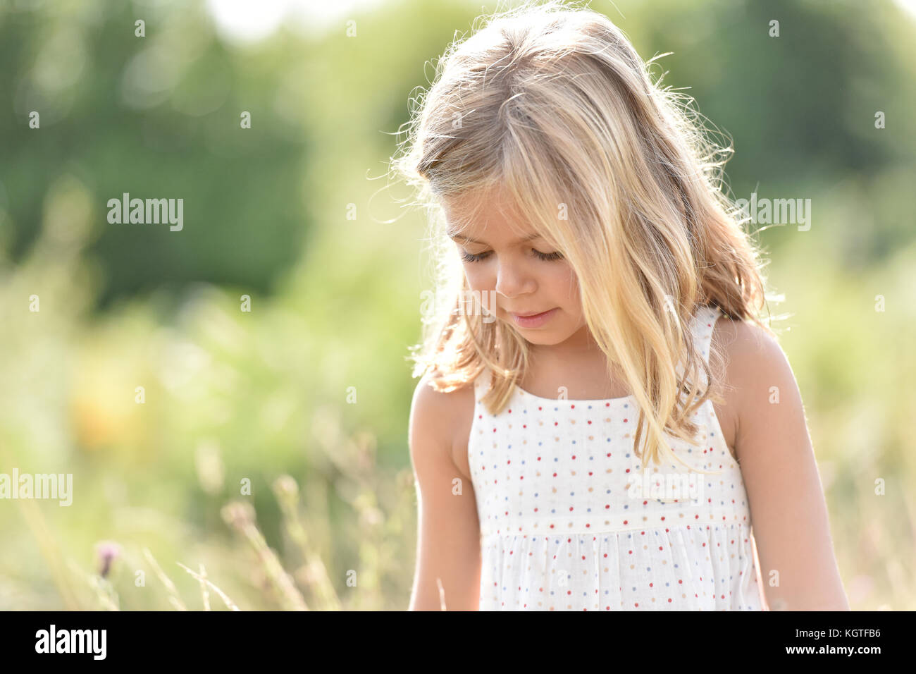 Portrait of cute little blond girl in countryside, summertime Stock ...