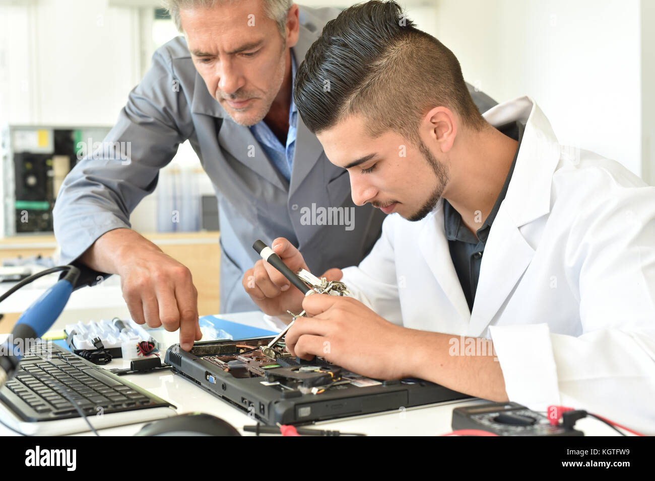 Student in electrical engineering course training with teacher Stock Photo