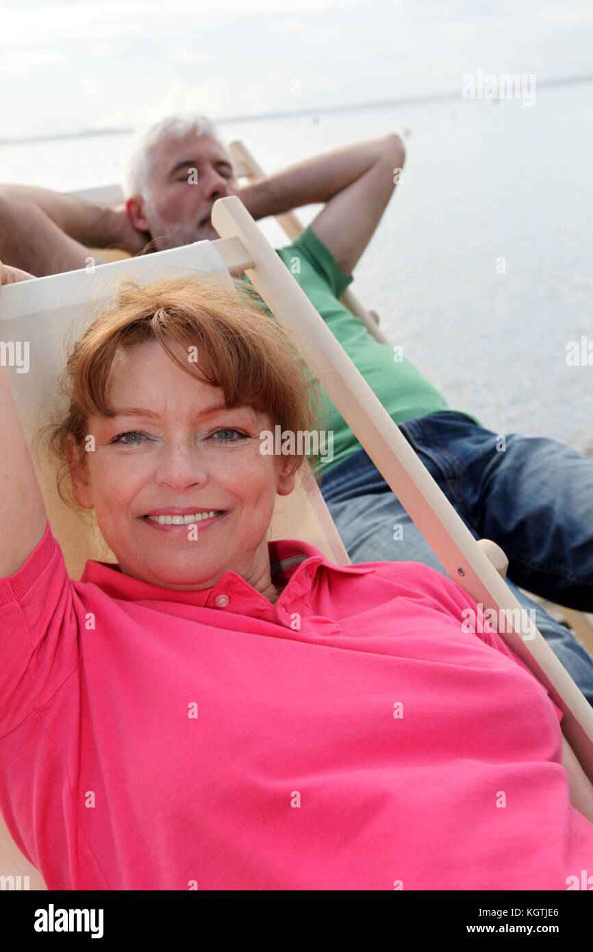 Senior couple resting in deck chairs Stock Photo - Alamy