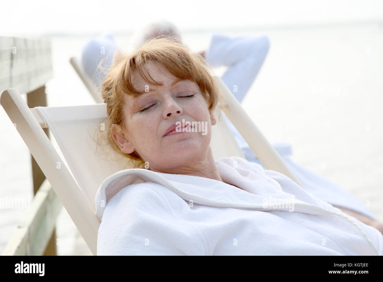 Senior couple resting in deckchairs Stock Photo - Alamy