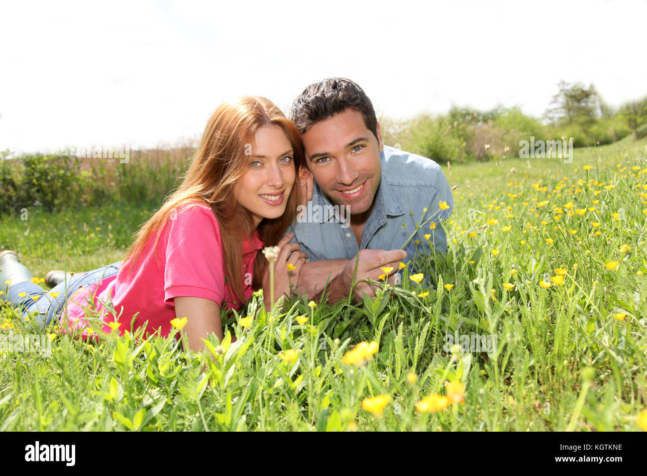 Couple of lovers laying donw in park Stock Photo - Alamy