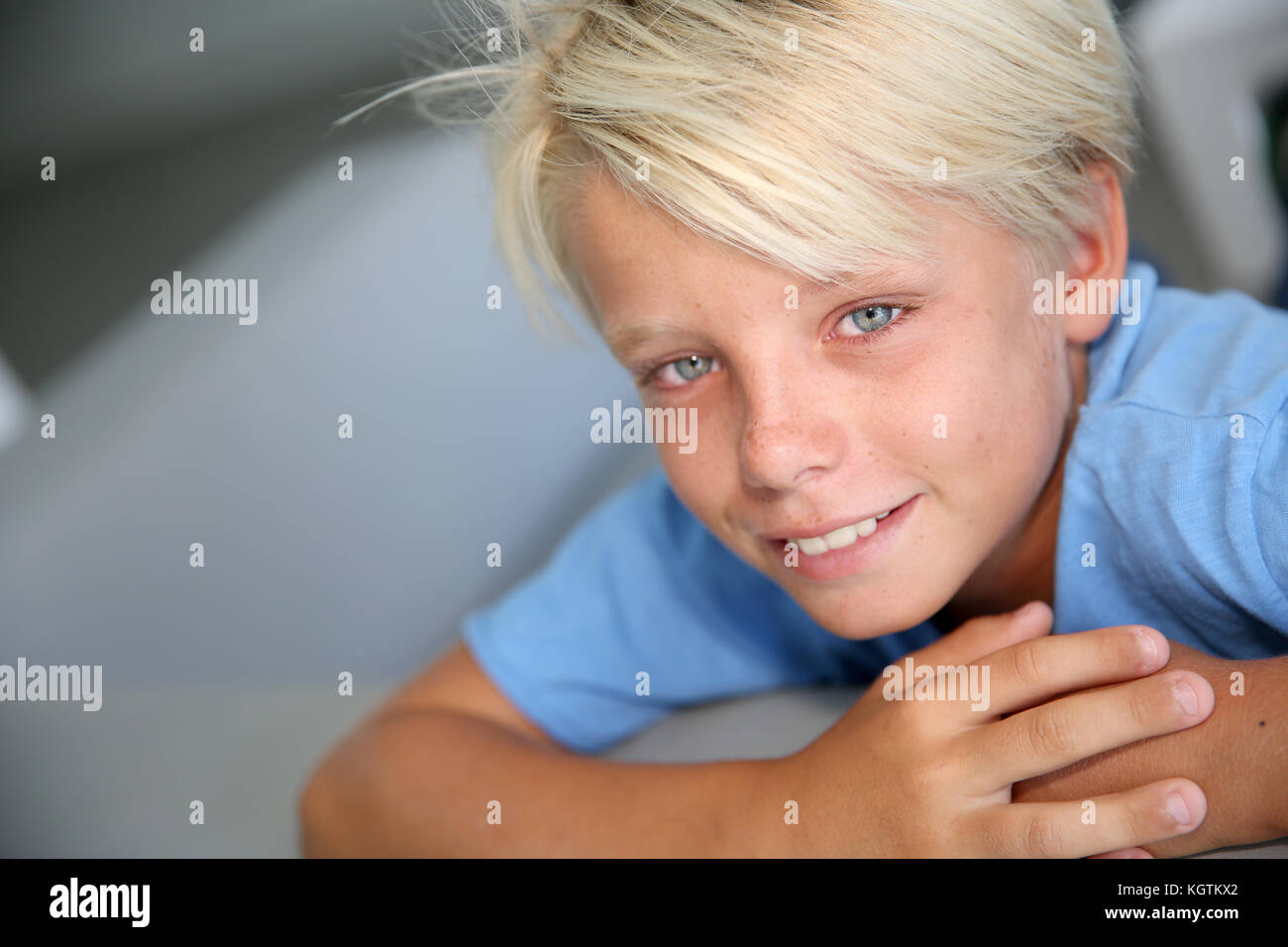 Portrait of young boy with blue eyes and shirt Stock Photo Alamy
