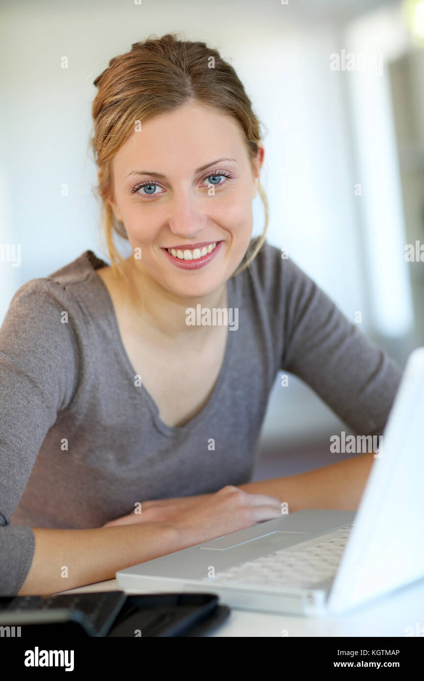 Beautiful young woman studying at home on laptop Stock Photo - Alamy