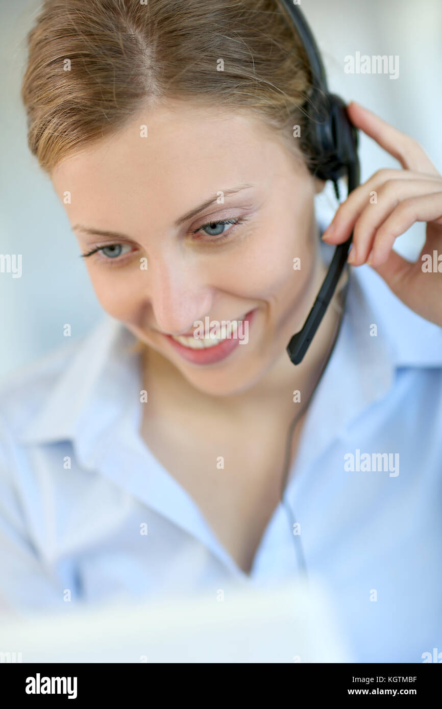 Closeup of attractive blond customer service assistant Stock Photo - Alamy