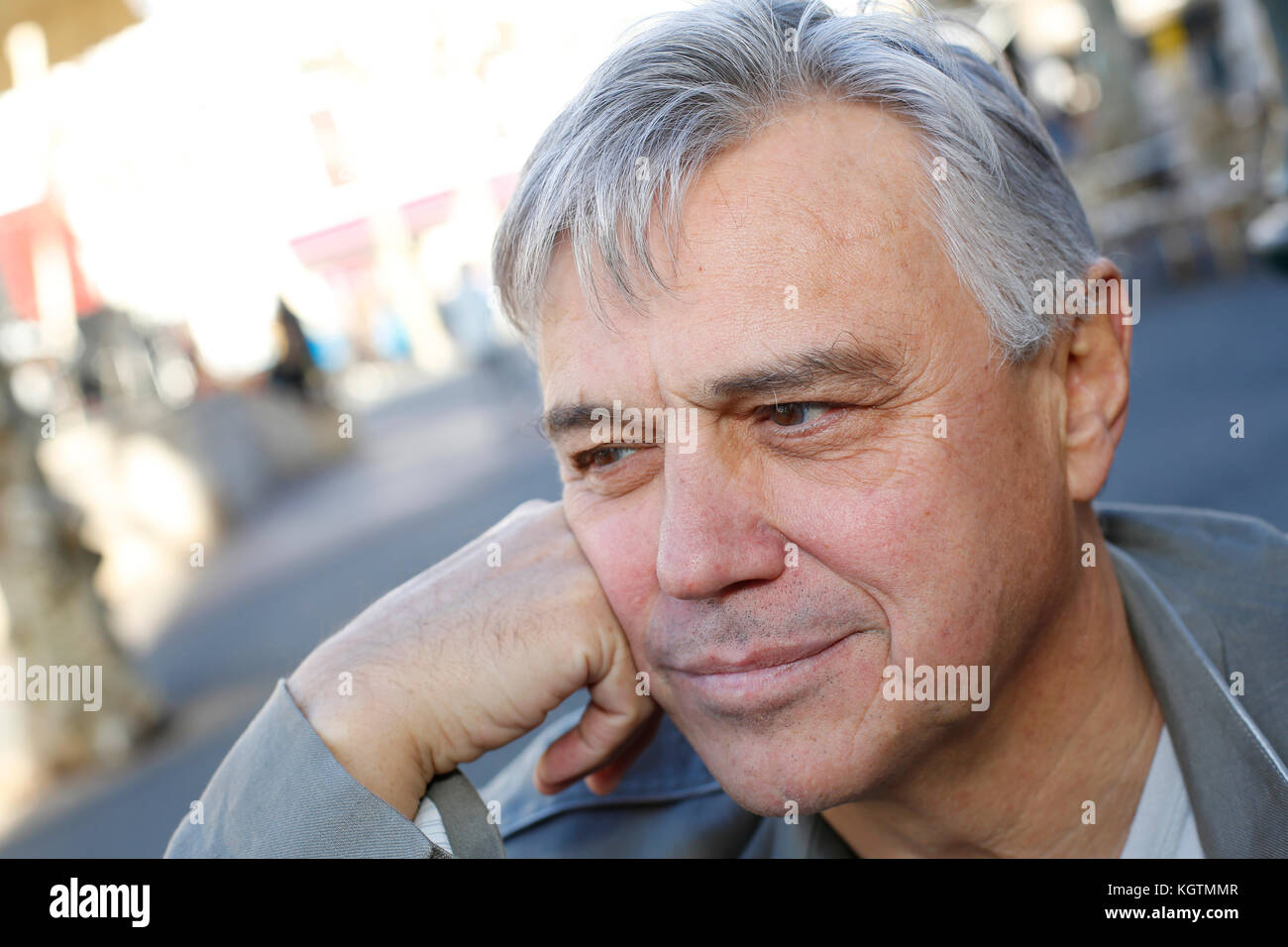 Portrait of smiling senior man standing outside Stock Photo - Alamy