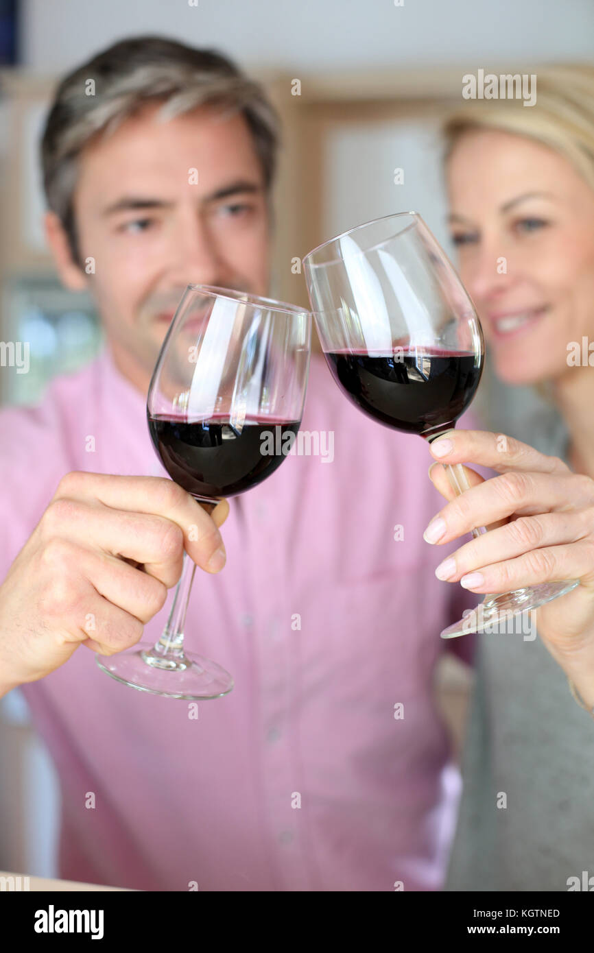 Couple drinking red wine in kitchen Stock Photo Alamy