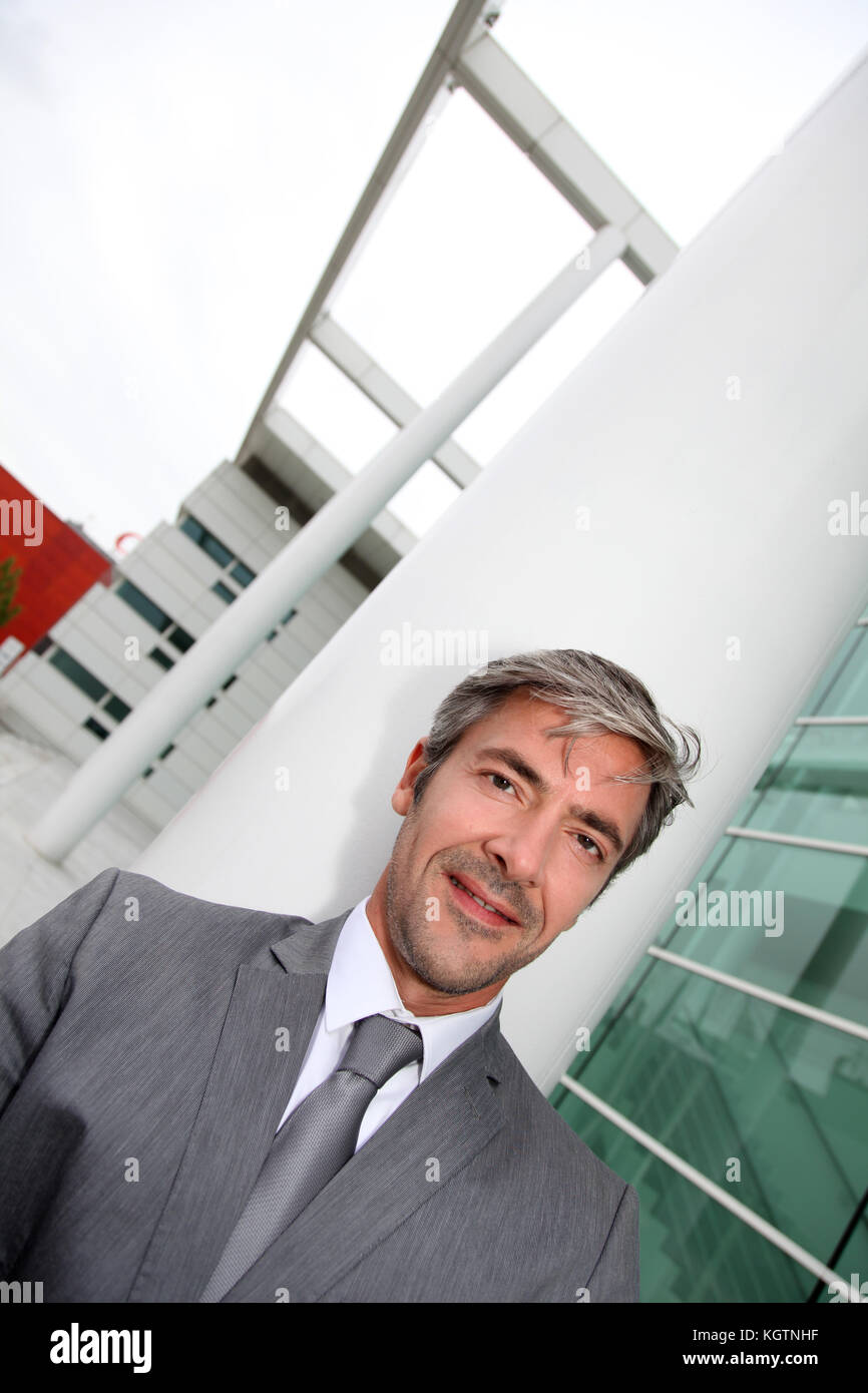 Man In Building Portrait of businessman standing in front of modern building Stock ...