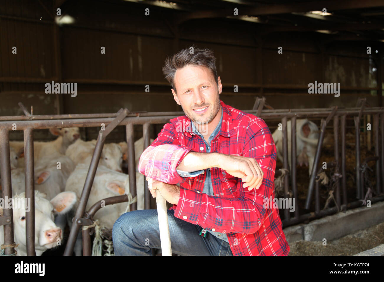 Portrait of smiling farmer in barn Stock Photo - Alamy