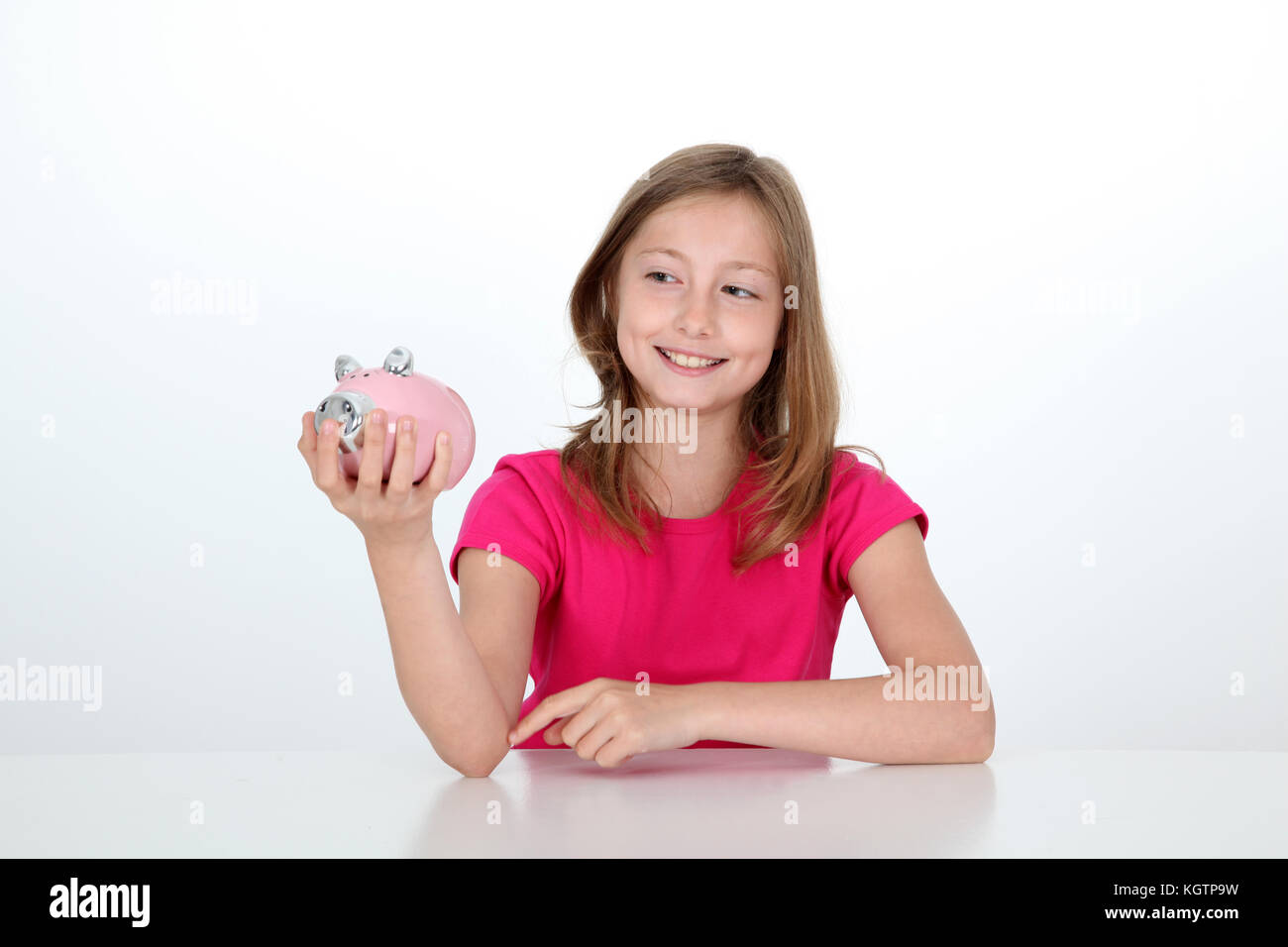 Smiling young girl holding piggy bank Stock Photo - Alamy