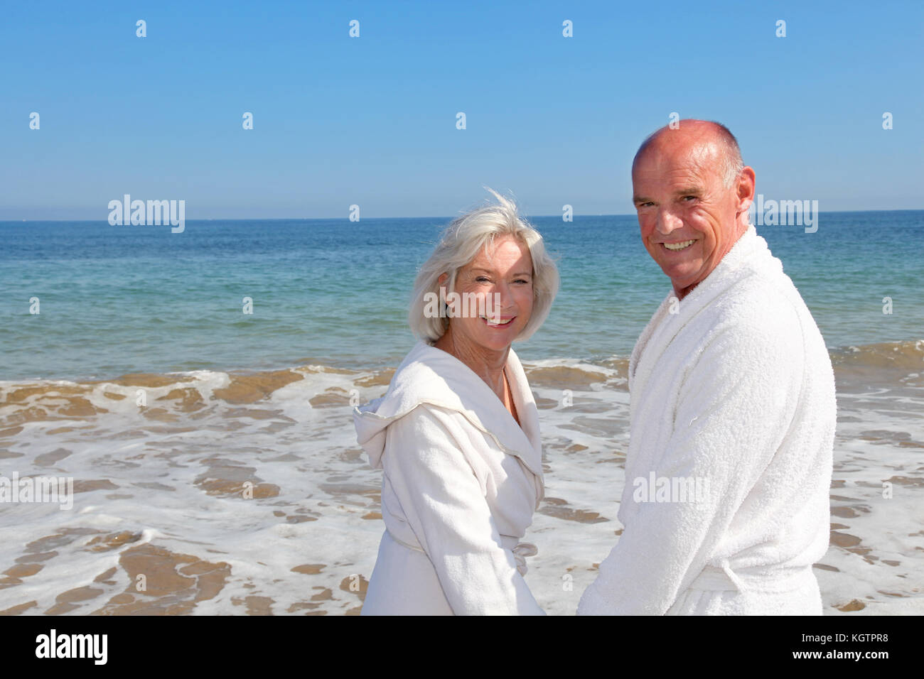 Portrait of senior couple relaxing on a resort beach Stock Photo - Alamy