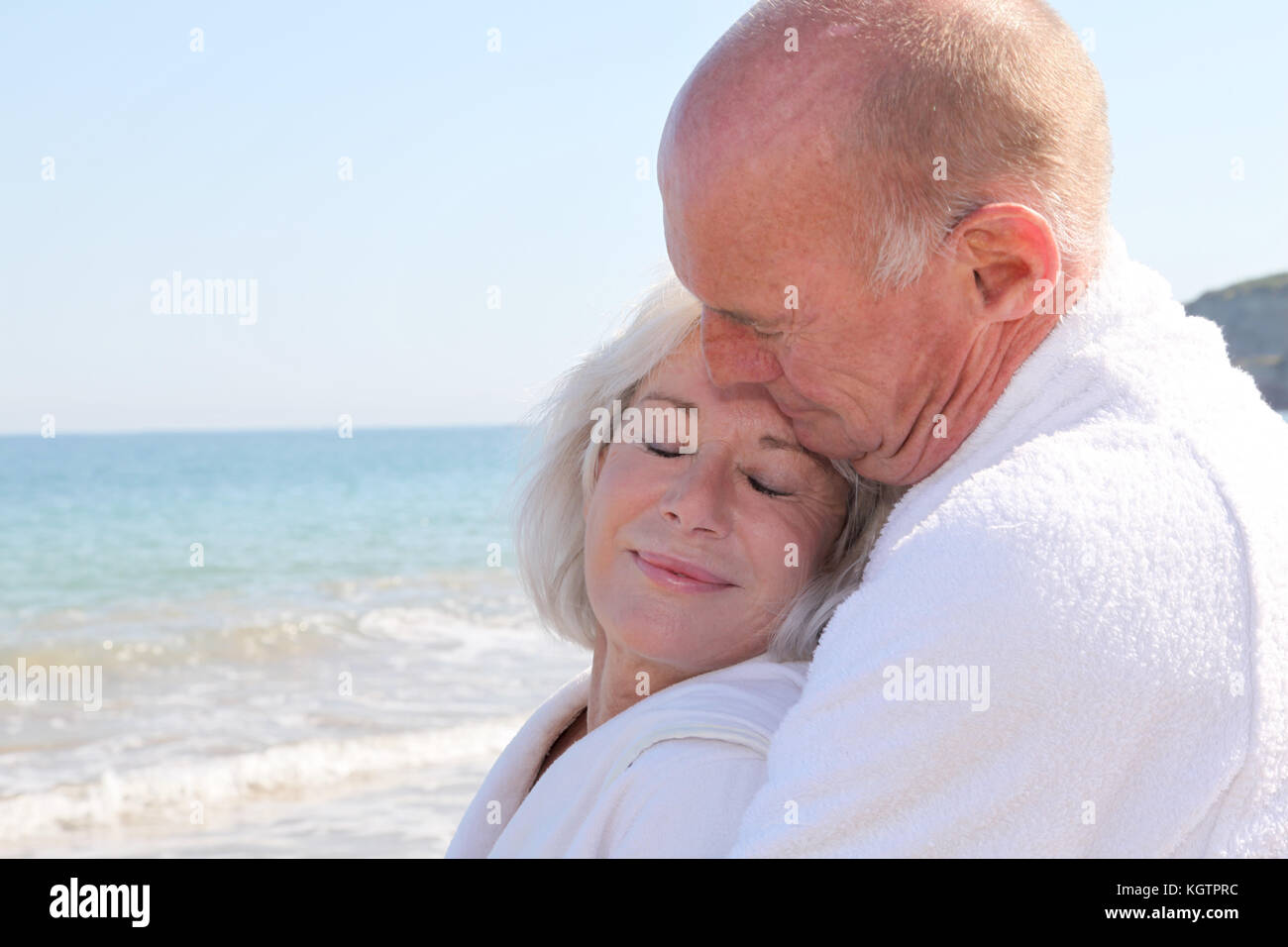 Portrait of senior couple relaxing on a resort beach Stock Photo - Alamy