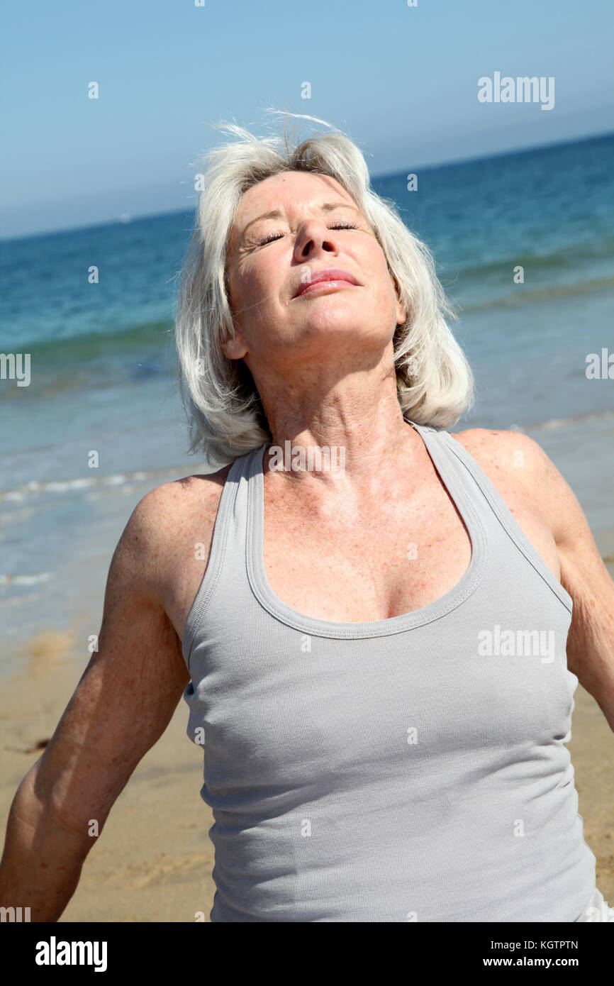 Senior woman relaxing on the beach Stock Photo - Alamy